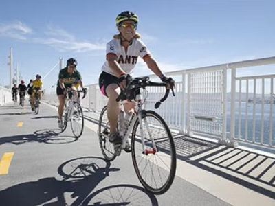 People riding bikes on a bridge.