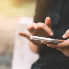 A close up of someone's hands operating a smartphone
