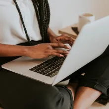 A close up of a laptop being operated on a person's lap