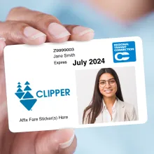 Photograph of a sample clipper card issued to Jame Smith that expires on July 2024.  It features a photo of a young woman, a Regional Transit Connection logo and a Clipper logo.  There is a message on the bottom of the card that reads "Affix Fare Sticker(s) Here"