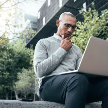 A man working on a laptop outdoors
