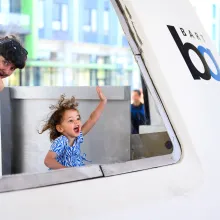mom and child waving out of a train window