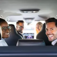 A group of people sharing a car ride.