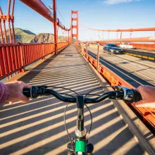 Point of view of someone riding a bicycle across a bridge