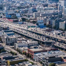 top view of a large city with two streets full of cars