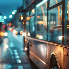 Buses driving trhough a city street at night