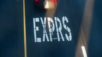 picture of a road with EXPRS on the lane car is passing it