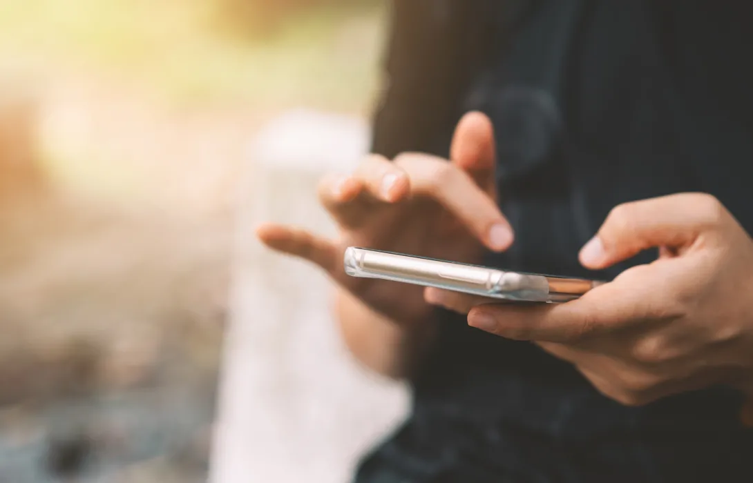 A close up of someone's hands operating a smartphone