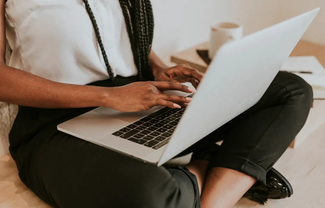 A close up of a laptop being operated on a person's lap