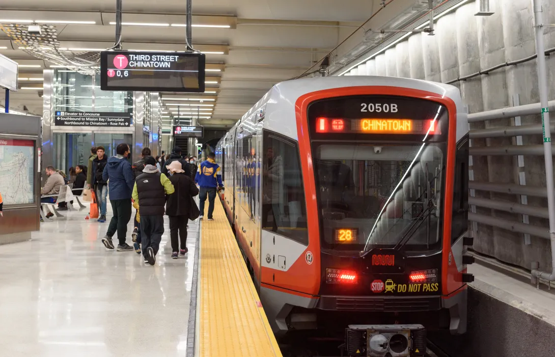 Commuters board a car at the Third Street Chinatown stop