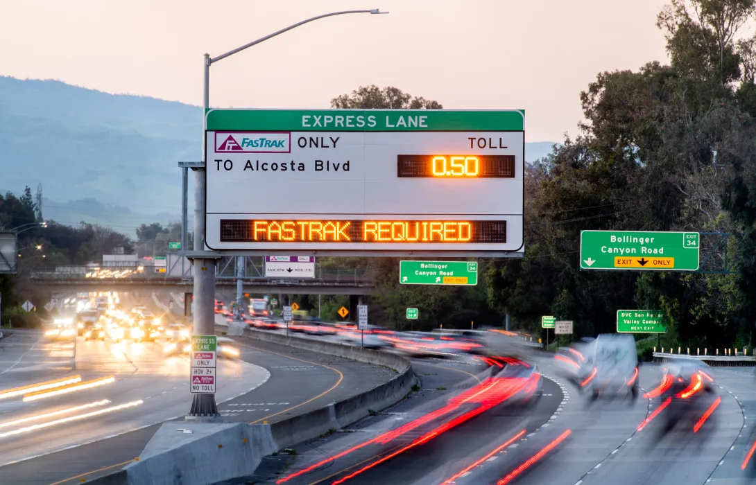 A freeway express lane sign displaying the toll to Alcosta Blvd, and indicating that Fastrak is required to pay the toll.