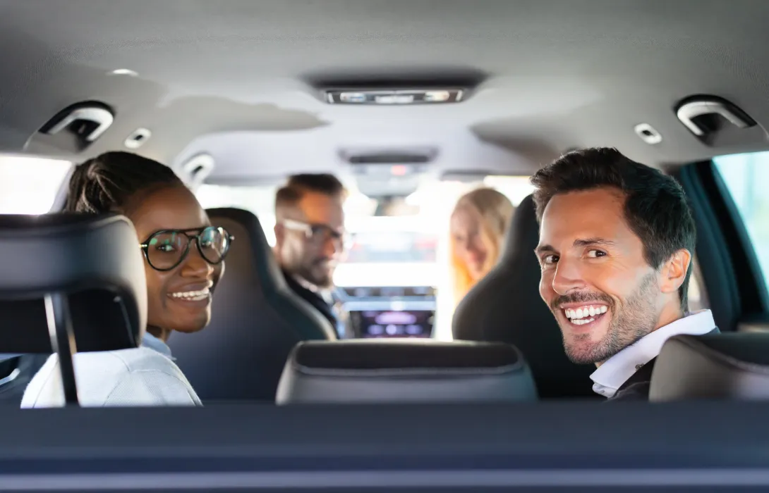 A group of people sharing a car ride.