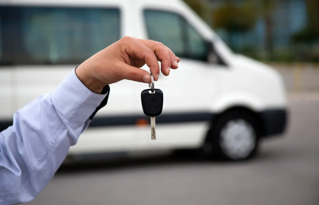 A hand holding car keys.