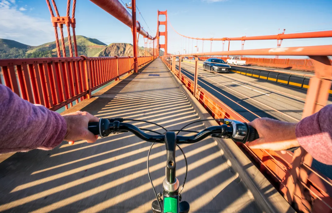 Point of view of someone riding a bicycle across a bridge