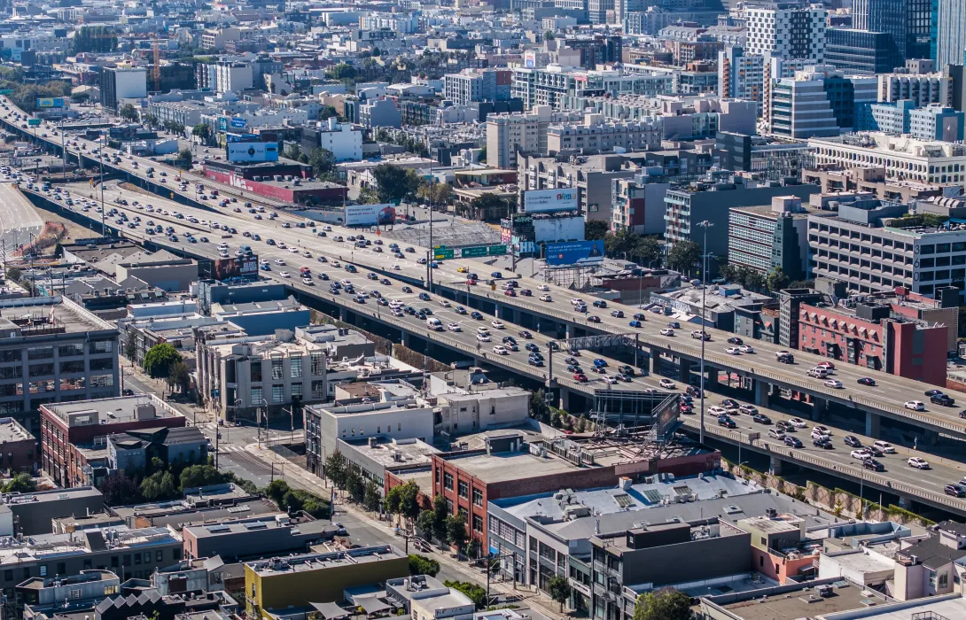 top view of a large city with two streets full of cars