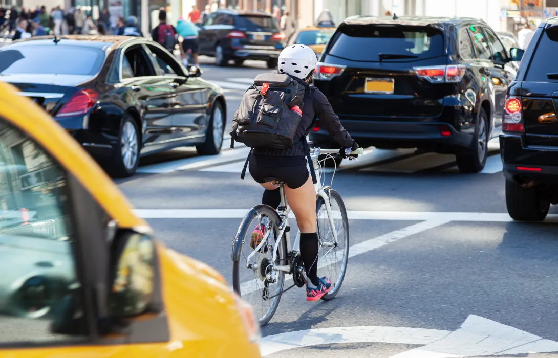 A woman riding a bike in traffic